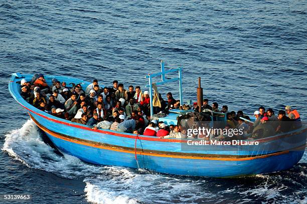 Boat loaded with illegal immigrant is seen on June 21, 2005 in Lampedusa, Italy. Tens of thousands of immigrants land on the Italian coast each year,...