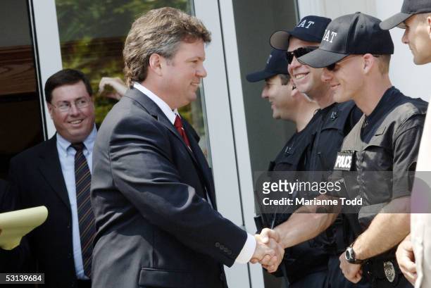 Mississippi Attorney General Jim Hood shakes hands with SWAT team members after Circuit Judge Marcus Gordon gave Edgar Ray Killen three consecutive...
