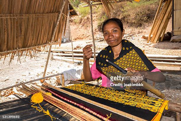 asian woman traditionally weaving fabric - flores indonesia stock pictures, royalty-free photos & images