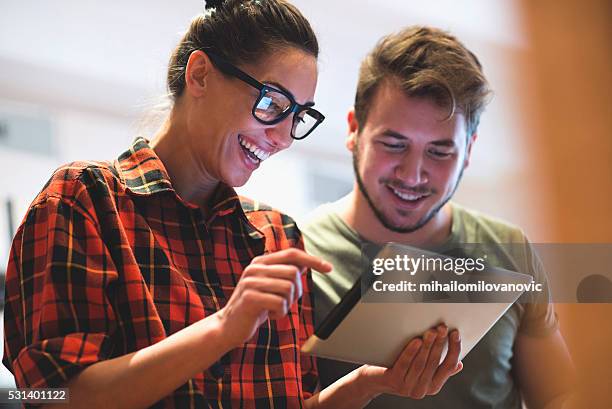 surfing the net and having fun - two people working together stock pictures, royalty-free photos & images