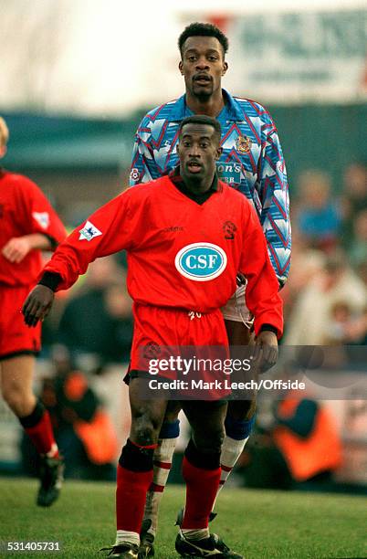 January 1994 FA Cup 3rd Round - Stockport County v Queens Park Rangers, Stockport striker Kevin Francis towers head and shoulders above Clive Wilson...