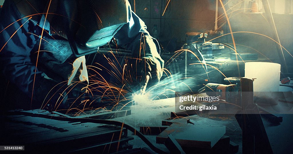 Welding two pieces of metal.