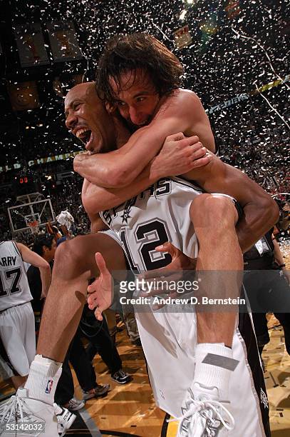 Manu Ginobili of the San Antonio Spurs jumps on the back of teammate Bruce Bowen as they celebrate winning the 2005 NBA Championship with their 81-74...
