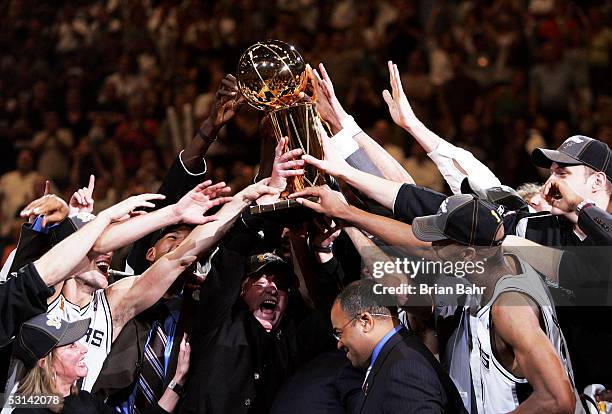 The San Antonio Spurs celebrate with the Larry O'Brien Trophy after defeating the Detroit Pistons in Game seven of the 2005 NBA Finals at SBC Center...