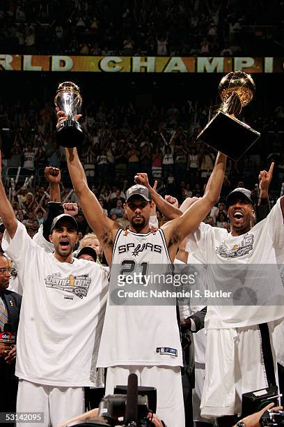 Finals MVP Tim Duncan of the San Antonio Spurs celebrates with the MVP Tophy in his left and the Larry O'Brien NBA Championship trophy in his right...