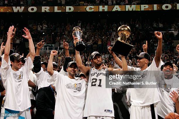 Finals MVP Tim Duncan of the San Antonio Spurs celebrates with the MVP Tophy in his left and the Larry O'Brien NBA Championship trophy with teammate...