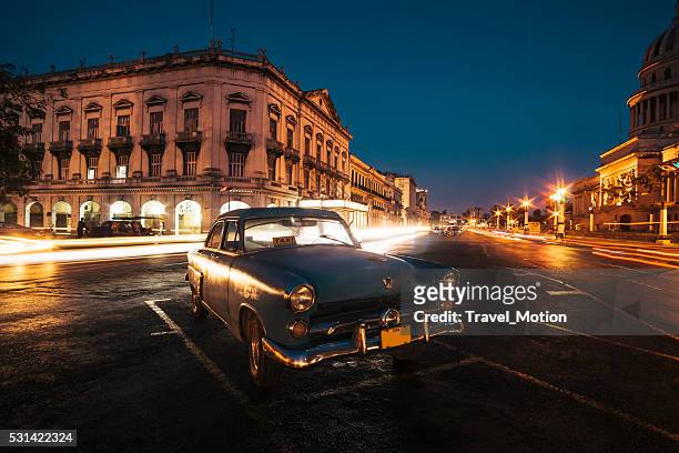 vintage car parked in the street at night, havana, cuba - cuba night stock pictures, royalty-free photos & images