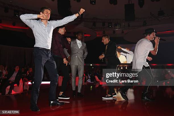 Thomas Muller, Robert Lewandowski, david Alba and Rafinha dance as music band, OneRepublic performs at the FC Bayern Muenchen Bundesliga Champions...