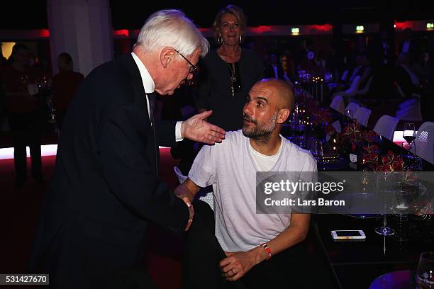 President Reinhard Rauball talks to Bayern Muenchen team coach Josep Guardiola at the FC Bayern Muenchen Bundesliga Champions Dinner at the...