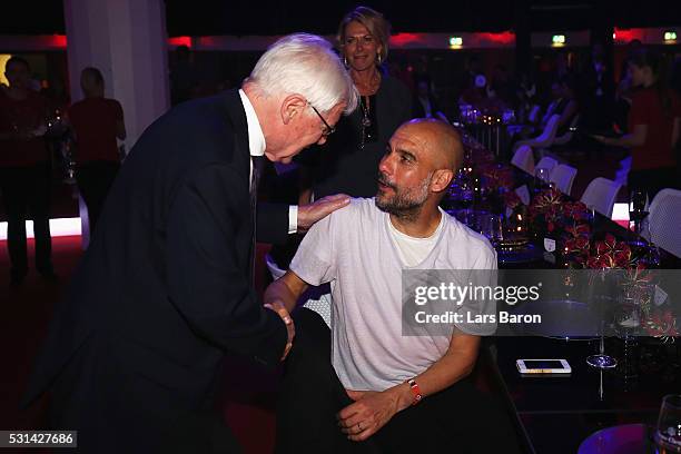 President Reinhard Rauball talks to Bayern Muenchen team coach Josep Guardiola at the FC Bayern Muenchen Bundesliga Champions Dinner at the...