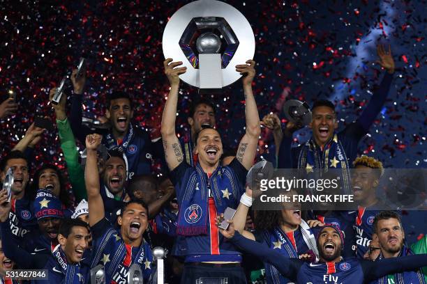 Paris Saint-Germain's Swedish forward Zlatan Ibrahimovic holds the trophy on the podium after winning the French L1 title at the end of the French L1...