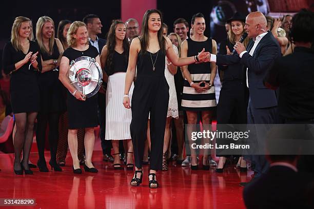 Lena Lotzen of FC Bayern Muenchen women team is interviewed by speaker Stefan Lehmann during the Bundesliga Champions Dinner at the Postpalast on May...