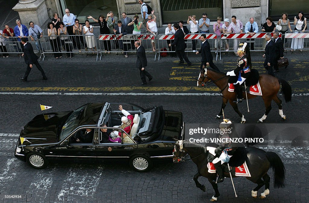 Pope Benedict XVI waves to the people as