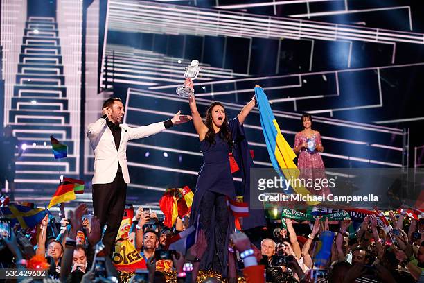 Host Mans Zelmerlow and Eurovision Song Contest winner 2016 Jamala representing Ukraine is seen on stage with her award at the Ericsson Globe on May...
