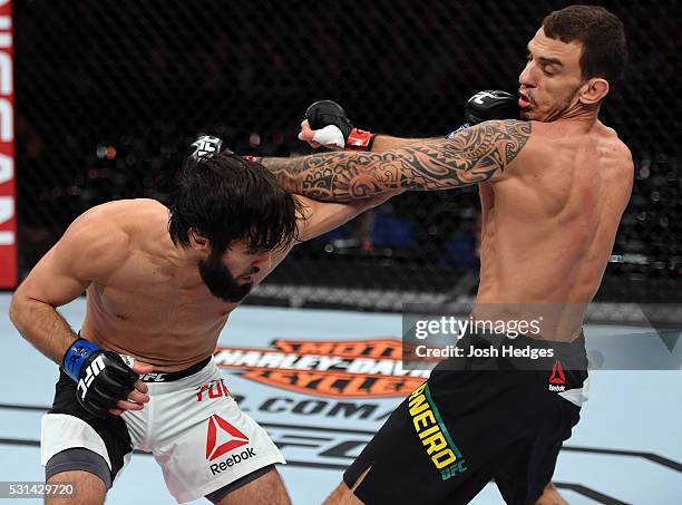 Zubaira Tukhugov of Russia punches Renato Moicano of Brazil in their featherweight bout during the UFC 198 event at Arena da Baixada stadium on May...