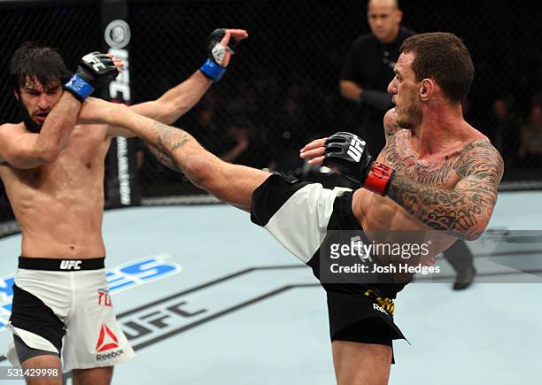 Renato Moicano of Brazil kicks Zubaira Tukhugov of Russia in their featherweight bout during the UFC 198 event at Arena da Baixada stadium on May 14,...
