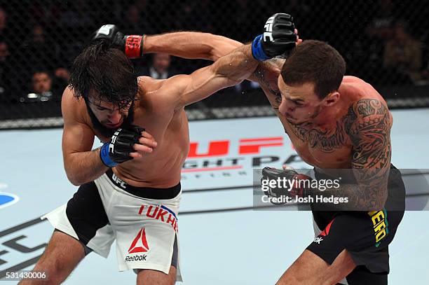 Zubaira Tukhugov of Russia punches Renato Moicano of Brazil in their featherweight bout during the UFC 198 event at Arena da Baixada stadium on May...