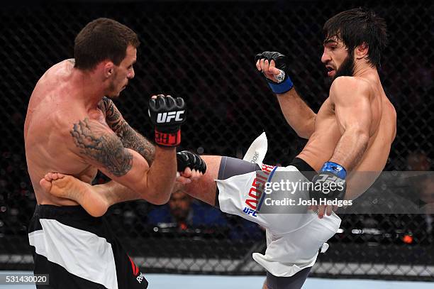 Zubaira Tukhugov of Russia kicks Renato Moicano of Brazil in their featherweight bout during the UFC 198 event at Arena da Baixada stadium on May 14,...