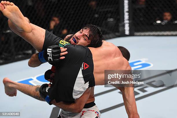 Zubaira Tukhugov of Russia takes down Renato Moicano of Brazil in their featherweight bout during the UFC 198 event at Arena da Baixada stadium on...