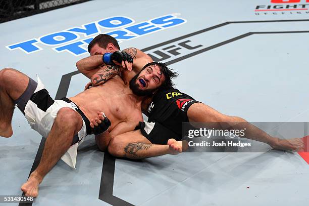 Renato Moicano of Brazil controls the body of Zubaira Tukhugov of Russia in their featherweight bout during the UFC 198 event at Arena da Baixada...