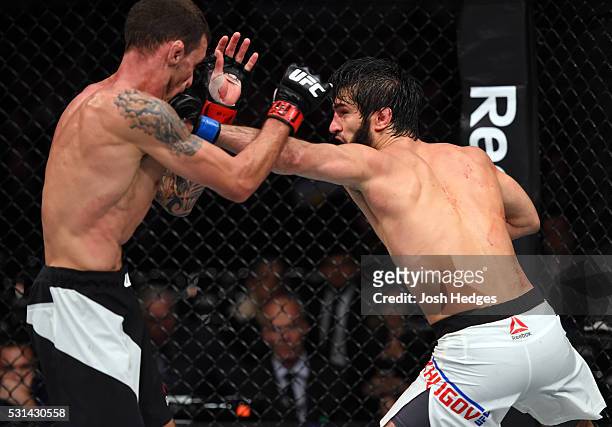 Zubaira Tukhugov of Russia punches Renato Moicano of Brazil in their featherweight bout during the UFC 198 event at Arena da Baixada stadium on May...