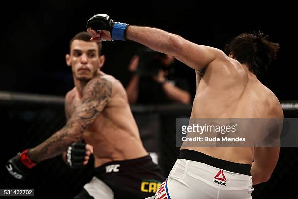 Renato Mocaio of Brazil punches Zubaira Tukhugov of Russia in their featherweight bout during the UFC 198 at Arena da Baixada stadium on May 14, 2016...
