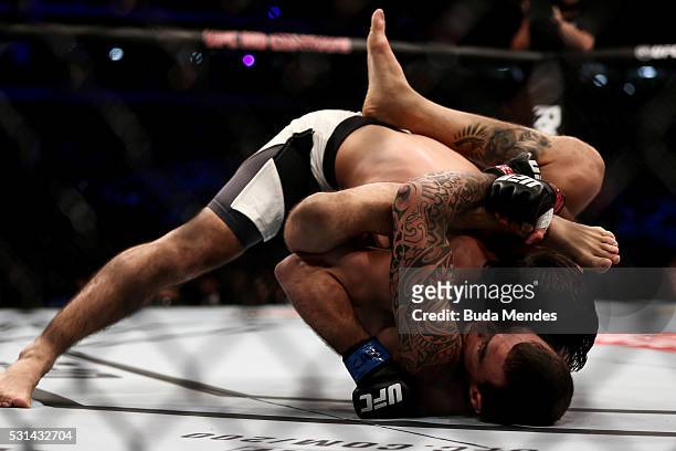 Renato Mocaio of Brazil submits Zubaira Tukhugov of Russia in their featherweight bout during the UFC 198 at Arena da Baixada stadium on May 14, 2016...