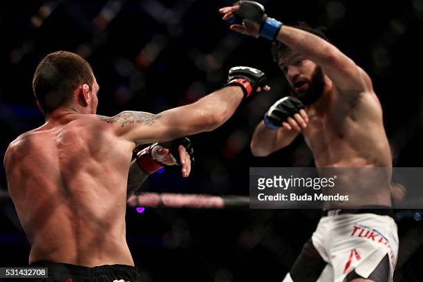 Renato Mocaio of Brazil punches Zubaira Tukhugov of Russia in their featherweight bout during the UFC 198 at Arena da Baixada stadium on May 14, 2016...