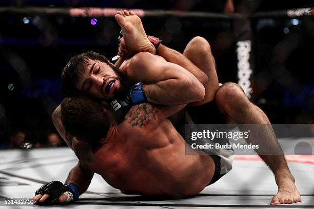 Renato Mocaio of Brazil submits Zubaira Tukhugov of Russia in their featherweight bout during the UFC 198 at Arena da Baixada stadium on May 14, 2016...