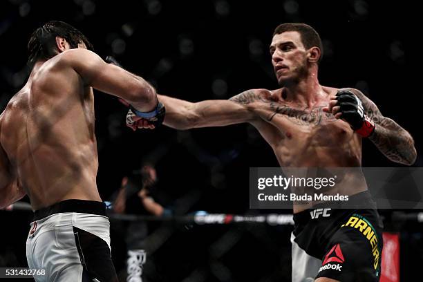 Renato Mocaio of Brazil punches Zubaira Tukhugov of Russia in their featherweight bout during the UFC 198 at Arena da Baixada stadium on May 14, 2016...