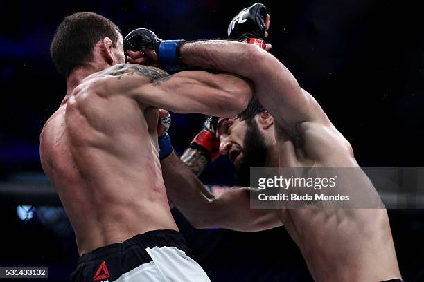 Zubaira Tukhugov of Russia punches Renato Mocaio of Brazil in their featherweight bout during the UFC 198 at Arena da Baixada stadium on May 14, 2016...