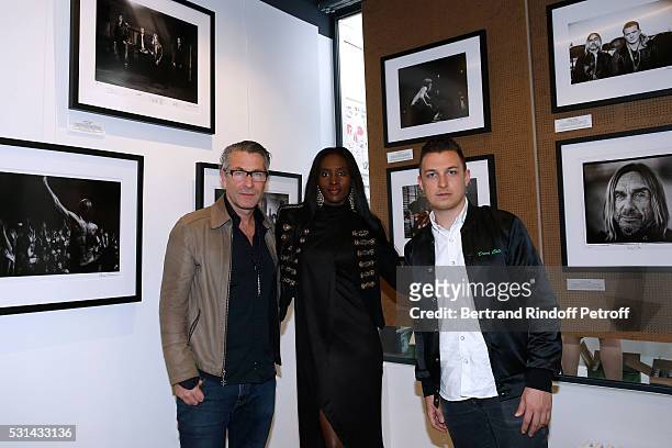 Photographer Andreas Neumann, his wife Khadija and photographer Matt Helders attend Iggy Pop 'Post Depression' Art Pictures Exhibition at French...