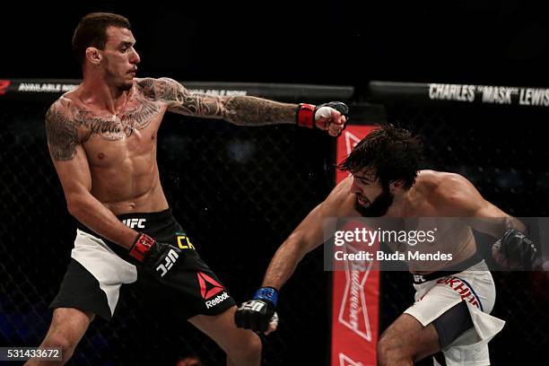 Zubaira Tukhugov of Russia punches Renato Mocaio of Brazil in their featherweight bout during the UFC 198 at Arena da Baixada stadium on May 14, 2016...