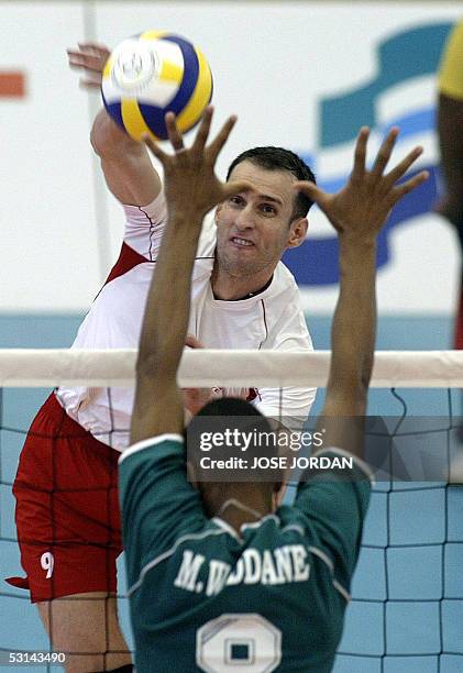 Turkish Osman Babagiary returns the ball to Mohammed Waddane from Morocco during their volleyball match of the XV Mediterranean Games, 24 June 2005...