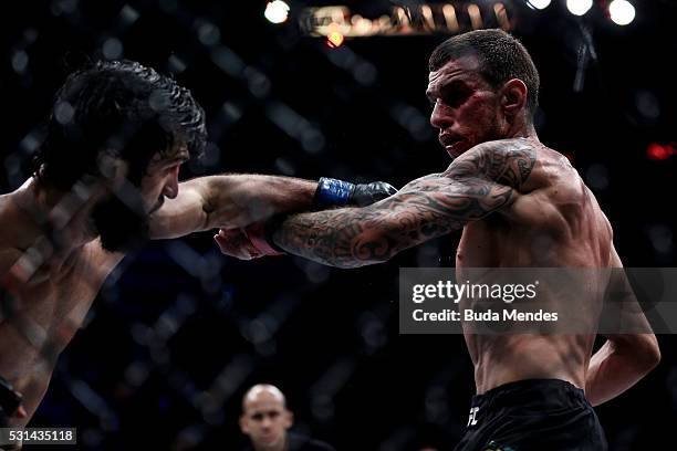 Zubaira Tukhugov of Russial punches Renato Mocaio of Brazil in their featherweight bout during the UFC 198 at Arena da Baixada stadium on May 14,...