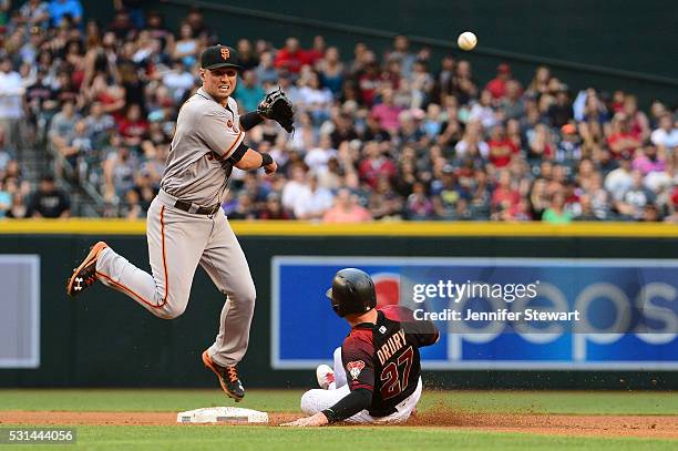 Joe Panik of the San Francisco Giants makes the force out at second base on Brandon Drury of the Arizona Diamondbacks in the fourth inning at Chase...