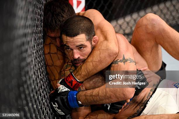 Demian Maia of Brazil controls the body of Matt Brown in their welterweight bout during the UFC 198 event at Arena da Baixada stadium on May 14, 2016...