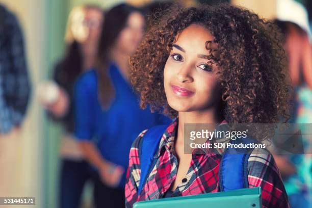 beautiful african american girl standing in school hallway - beautiful ethiopian girls stockfoto's en -beelden
