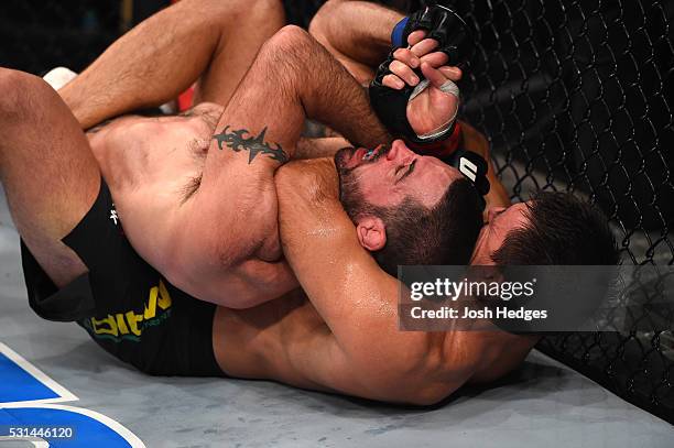 Demian Maia of Brazil controls the body of Matt Brown in their welterweight bout during the UFC 198 event at Arena da Baixada stadium on May 14, 2016...