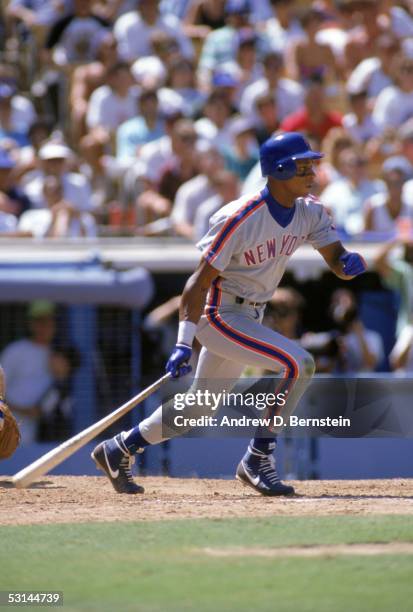 Darryl Strawberry of the New York Mets watches the flight of the ball as he follows through on his swing during a game against the Los Angeles...