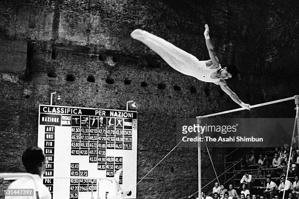 Yukio Endo of Japan competes in the Horizontal Bar of the Artistic Gymnastics Men's Team during the Rome Summer Olympic Games at Baths of Caracalla...