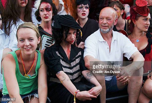 Michael and Emily Eavis pose with the cast of Carnesky's Ghost Train in the Midnight Carnival field of the Glastonbury Music Festival held at Worthy...