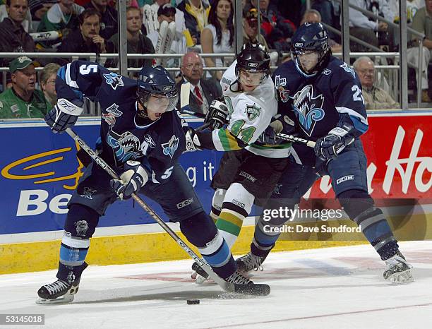 Patrick Coulombe of the Rimouski Oceanic controls the puck as teammate Francois Bolduc holds off Rob Schremp of the London Knights during the...