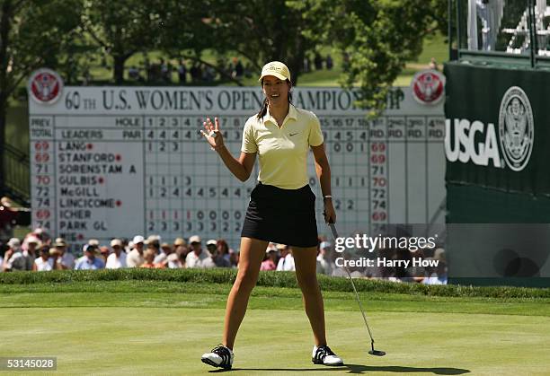 Michelle Wie waves to the crowd after making her putt on the eighteenth hole during the second round of the 60th U.S. Women's Open Championship at...