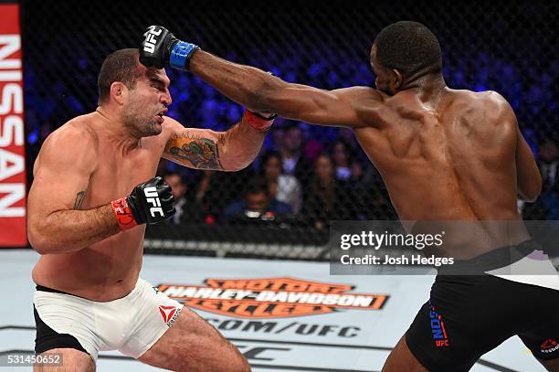 Corey Anderson punches Mauricio 'Shogun' Rua of Brazil in their light heavyweight bout during the UFC 198 event at Arena da Baixada stadium on May...