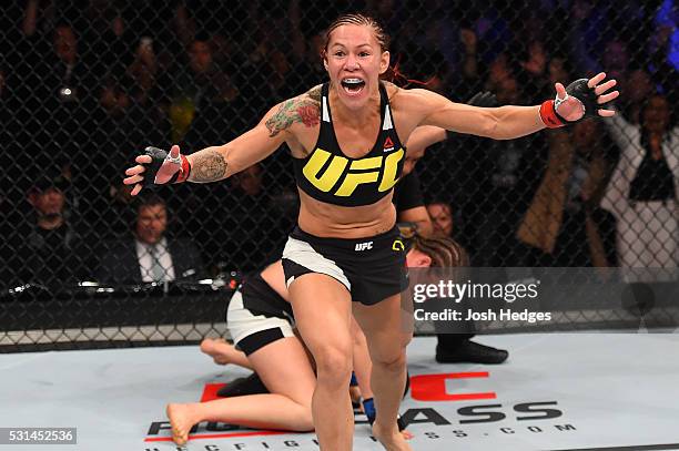 Cristiane 'Cyborg' Justino of Brazil celebrates after defeating Leslie Smith in their women's catchweight bout during the UFC 198 event at Arena da...