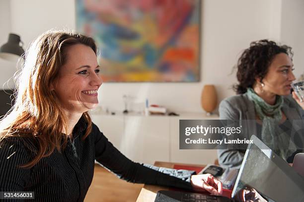 two business women at a meeting - amsterdam business stock pictures, royalty-free photos & images