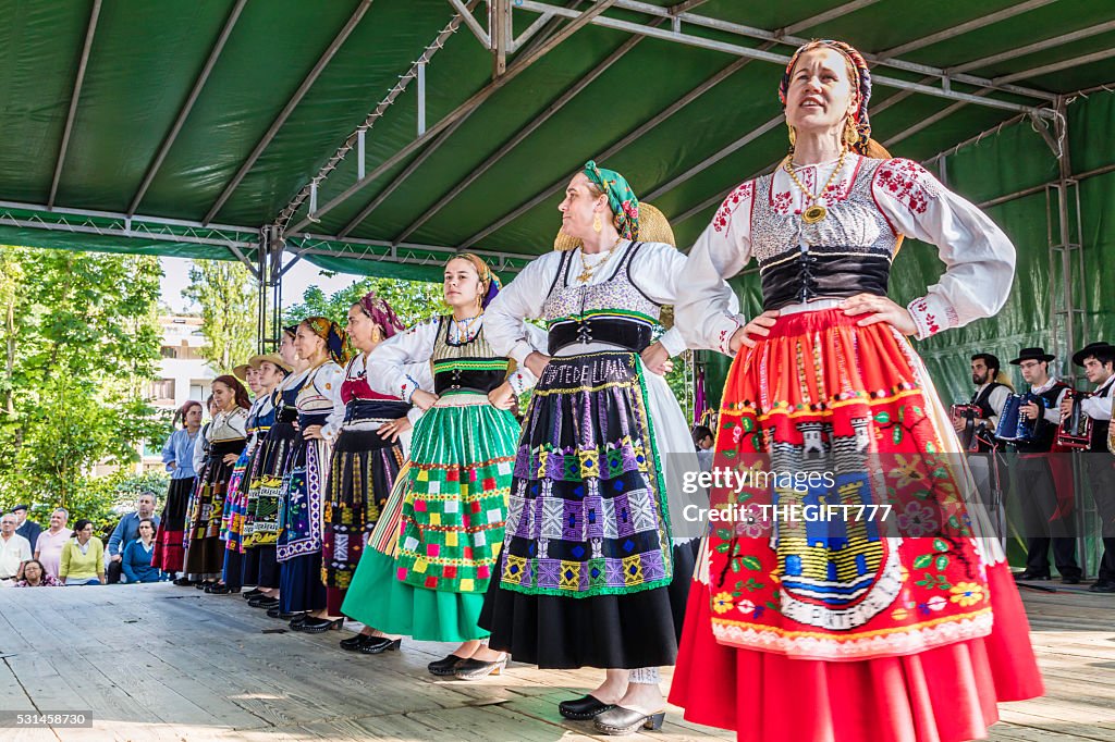 Folklore dancers singing on a platform