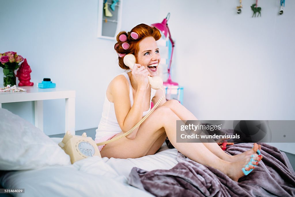 Girl Painting Her Nails and Talking On the Telephone