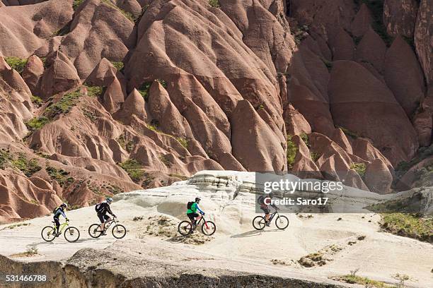 mountainbiking white tuff waves in cappadocia, turkey - göreme stock pictures, royalty-free photos & images